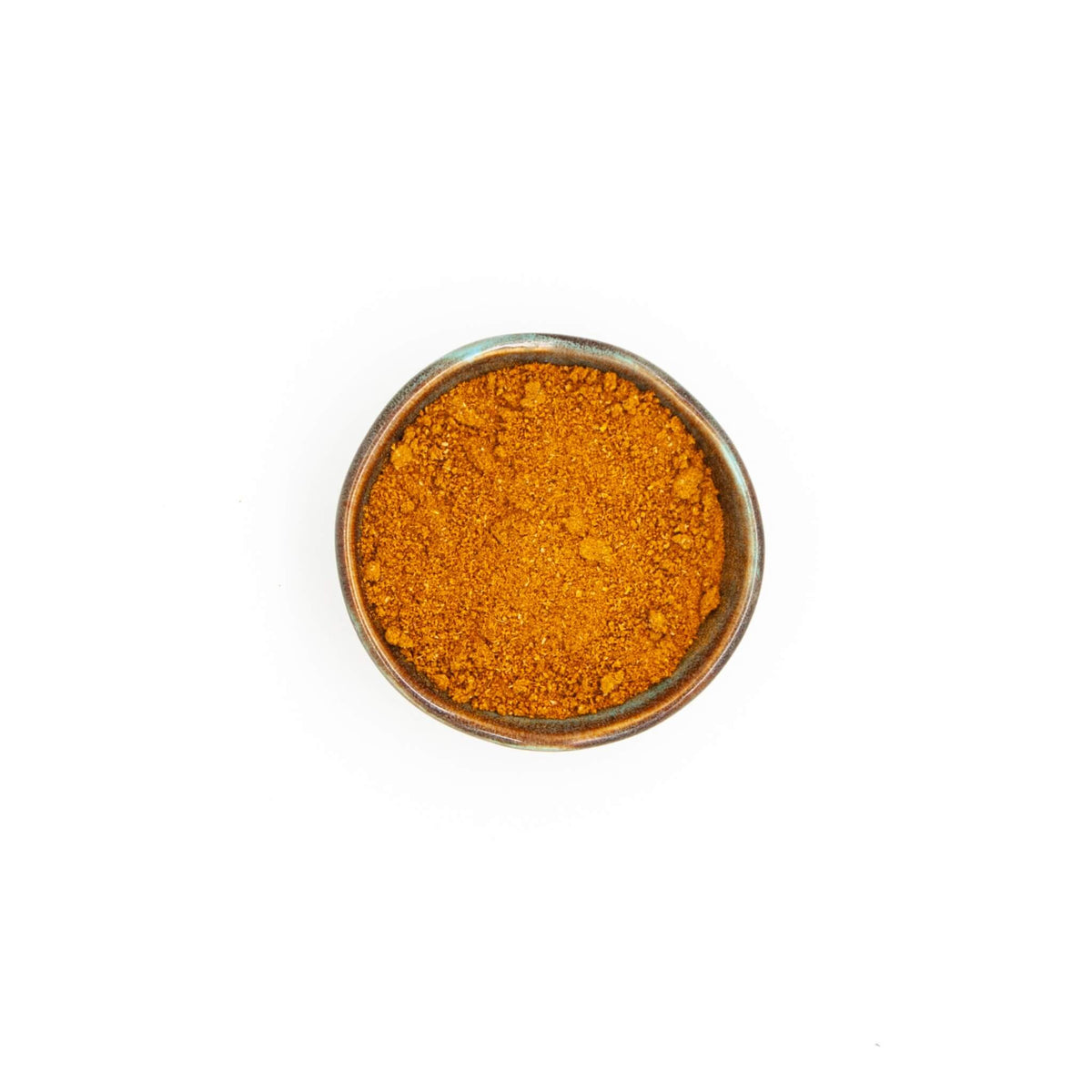 Bol de ras el hanout Épices Moralès vu du dessus, mélange doré pour tajines, couscous et légumes rôtis.